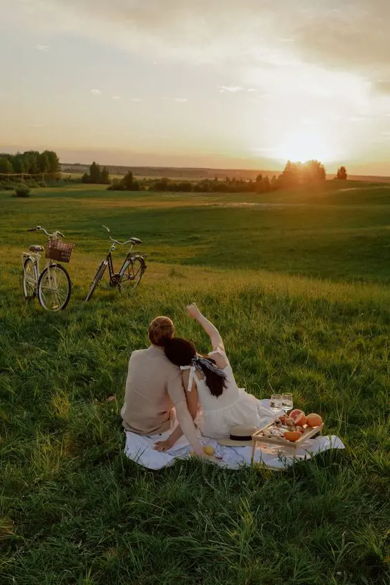 A couple enjoying romantic time during a picnic at a park. 