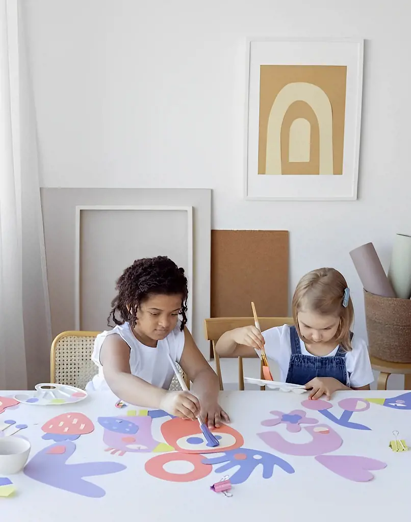 The photo captures two children engaged in creating artwork expressing their creativity and imagination