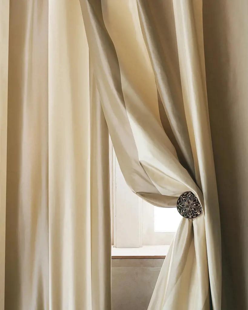 The picture features stunning cabana striped silk curtains beautifully adorned with curtain clips on the right side