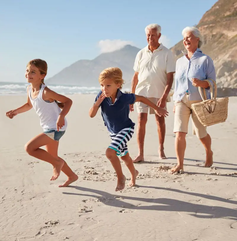 Grandparents spend their time with grandchildren at the beach