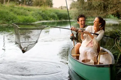 A young boy and a young girl enjoy fishing and Canoeing together. 