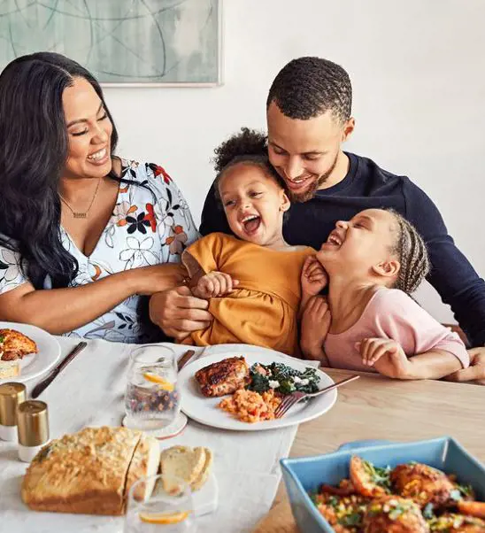 A family enjoy their meal together filled with laughter and joy