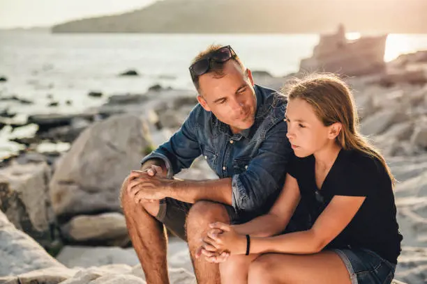 A father listening to his daughter in peace with no distraction