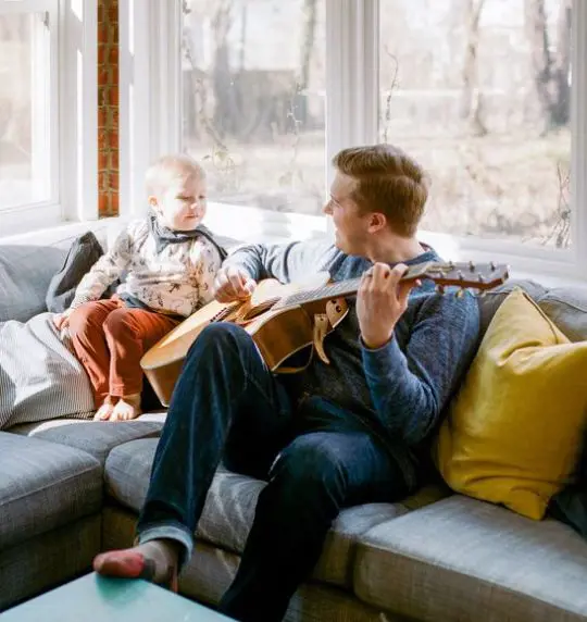 A father plays guitar for his son and the sweet moment is captured by Lissa Ryan