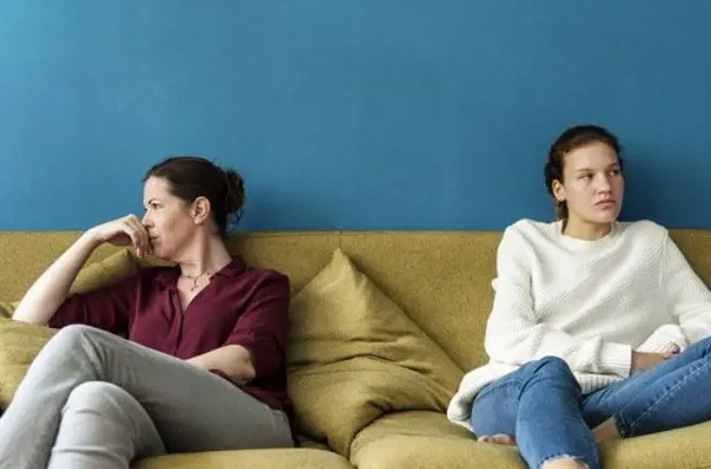 Mother and daughter facing away from each other after the argument