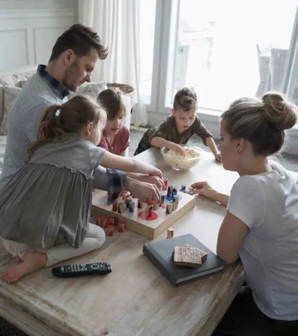 Parents playing games with their children as they spend some quality time