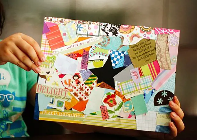 A child displays her collage made from various cut-outs and colorful papers