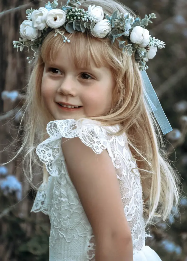 The girl looks stunning wearing a white Camellia flower crown atop her head