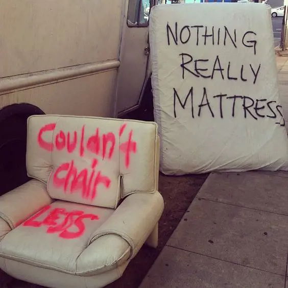 Thrown chair and mattress with puns written on them.