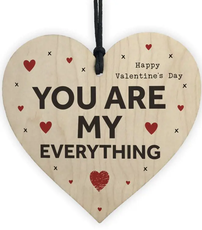 Valentine's Day message printed on a heart-shaped wooden board