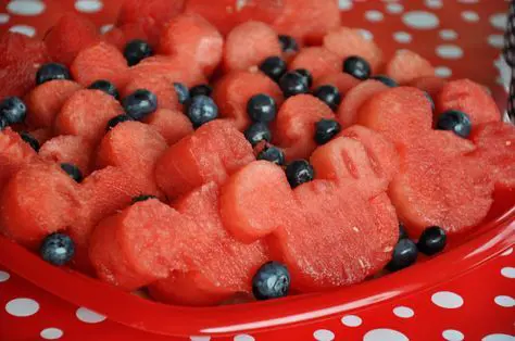 Watermelons decorated with black grapes for a birthday party. 